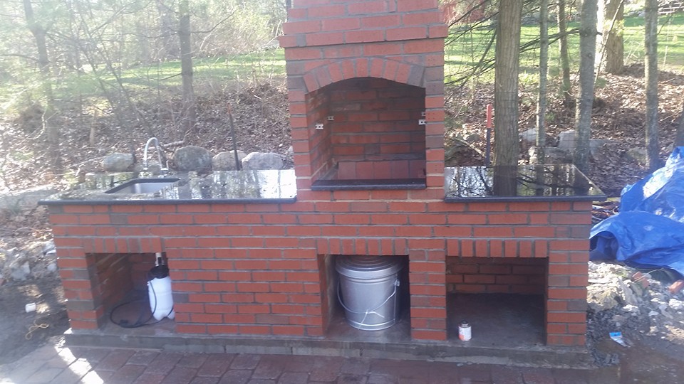 Brick outdoor fireplace and kitchen counter