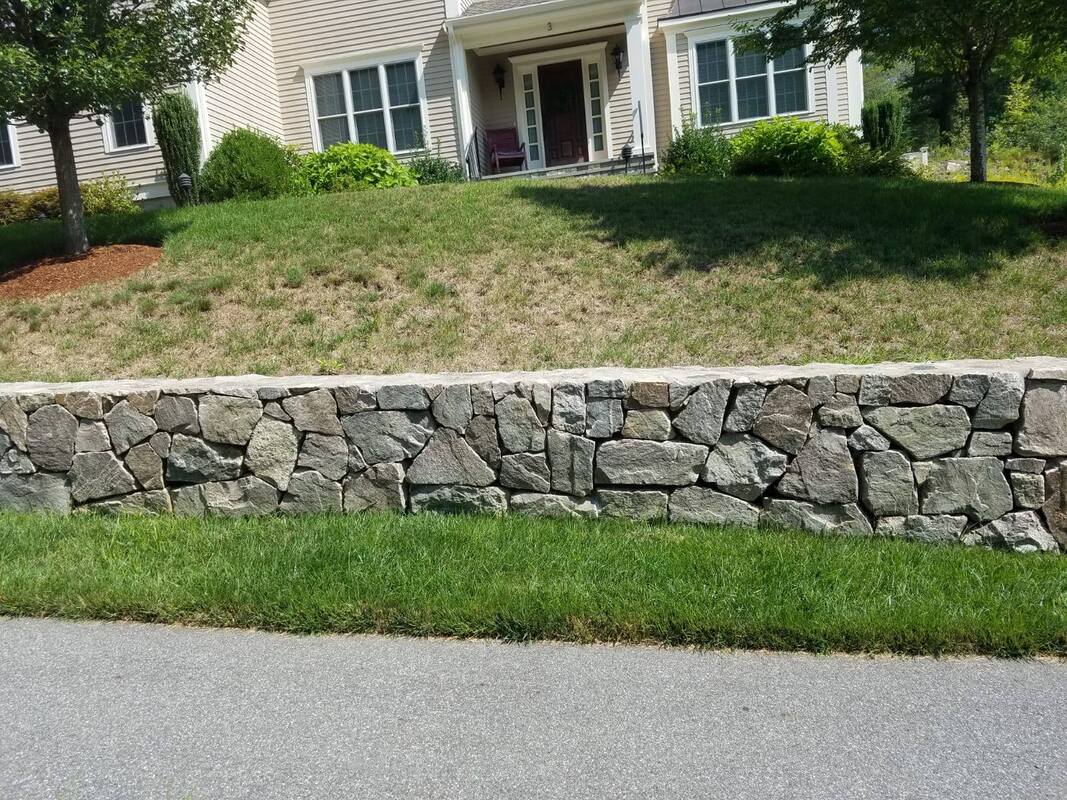 Fieldstone wall along a front lawn
