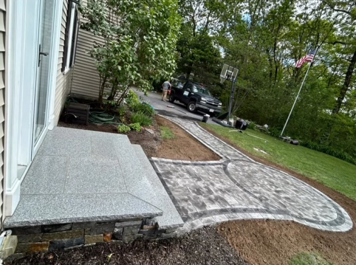 Granite landing over a stone base with paver path