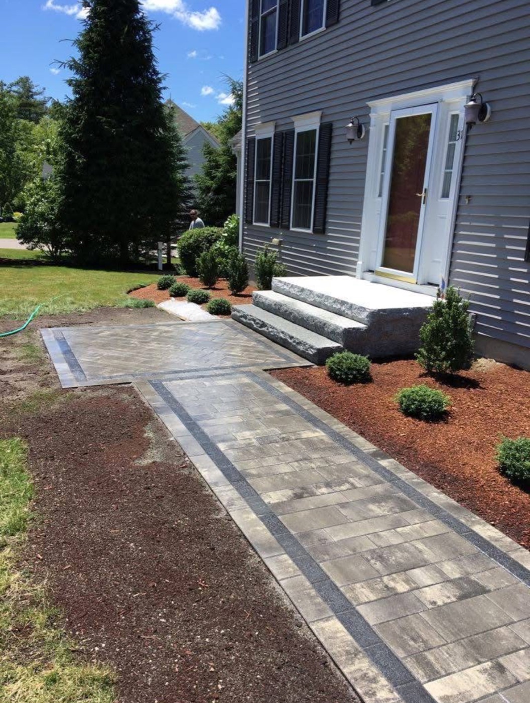 Granite steps with a bordered paver walkway