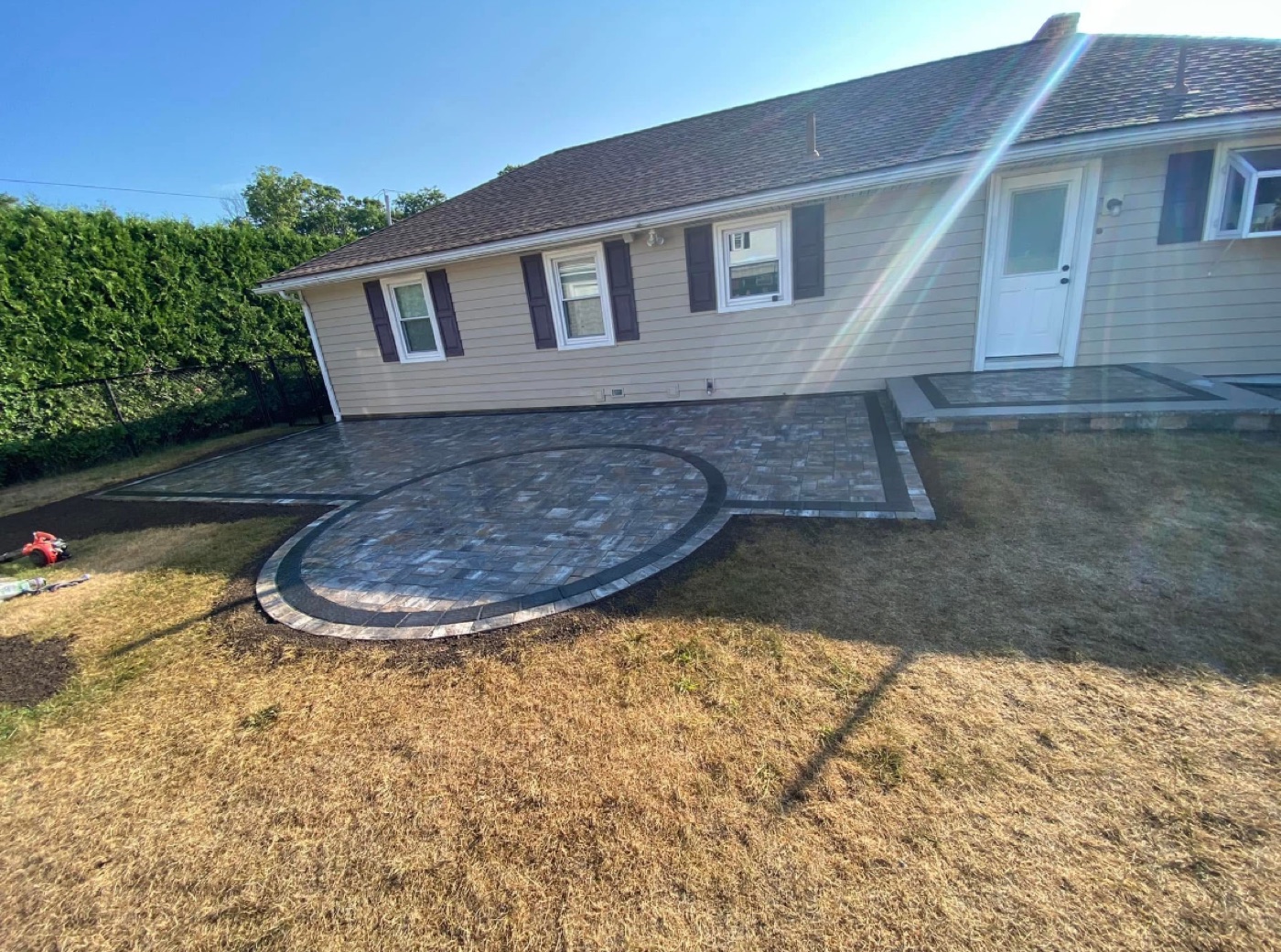 Backyard paver patio with a circular section