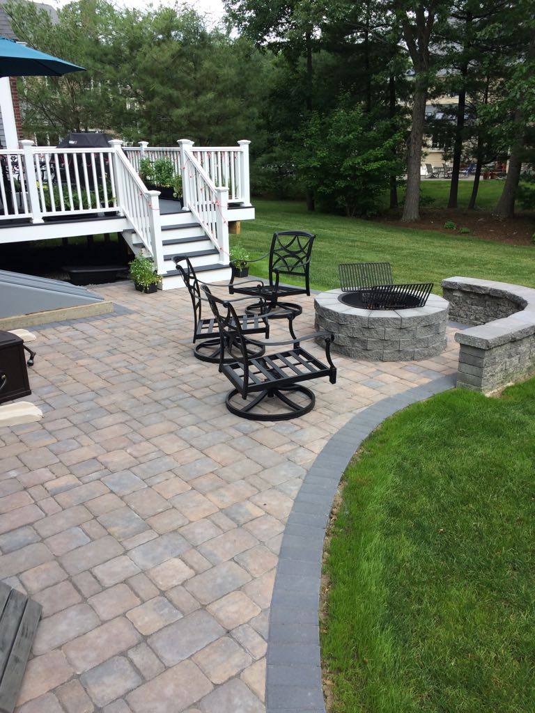 Paver patio with fire pit off a deck