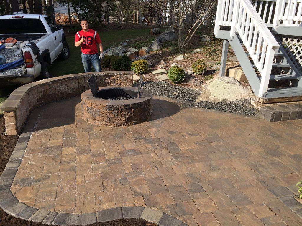 Paver patio with fire pit and curved seat wall