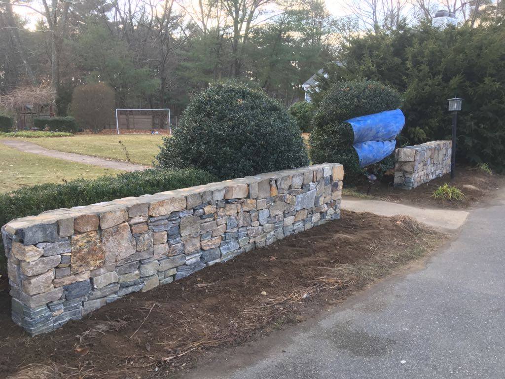 Stone wall with a matching pillar