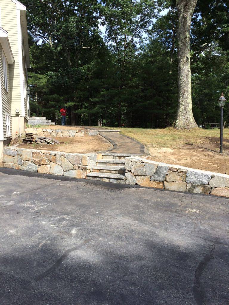Stone retaining wall with built-in steps